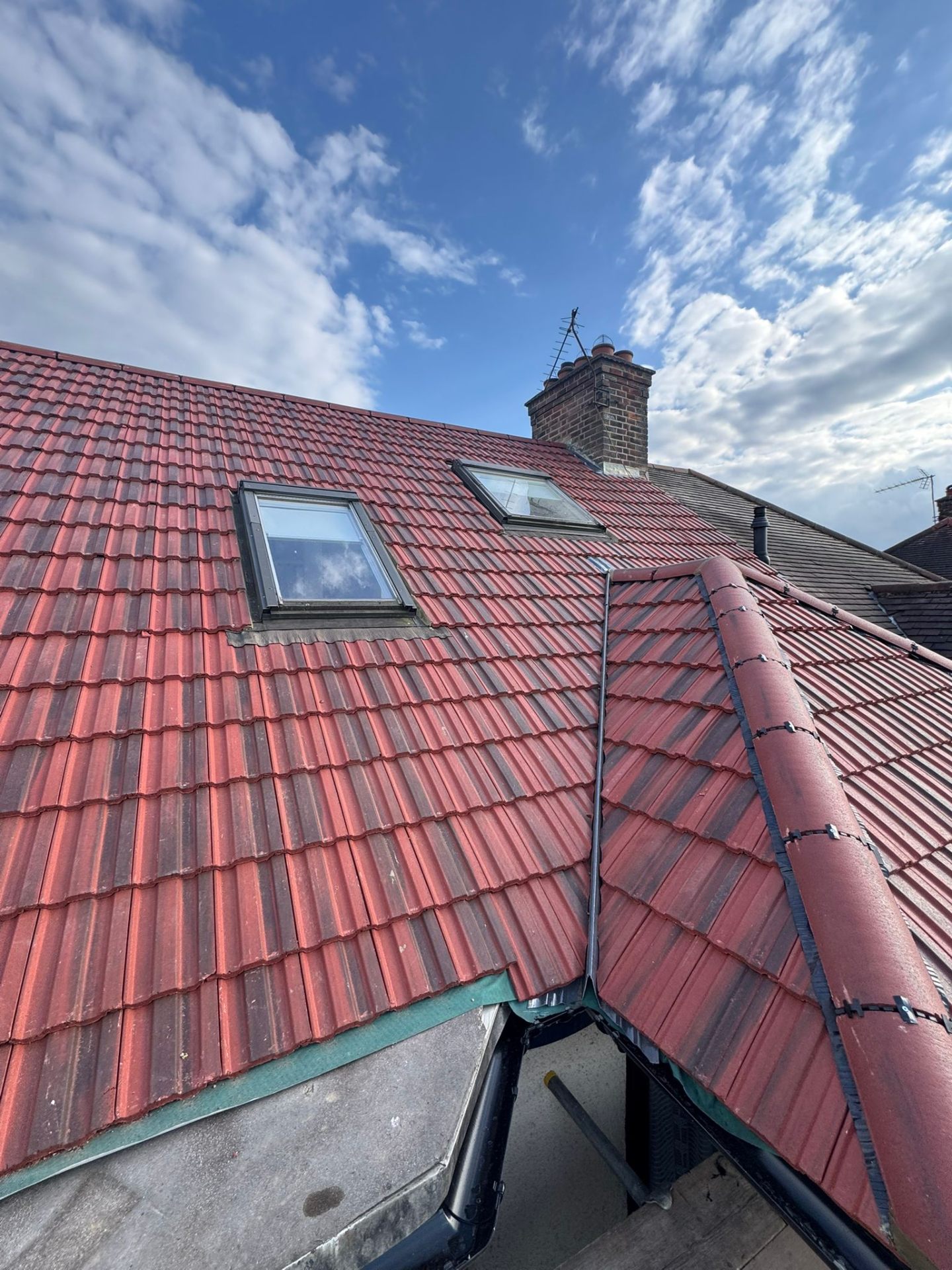 Newly re-tiled pitched roof with Velux windows in Hertfordshire